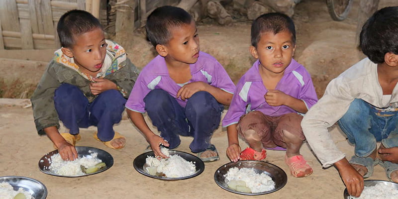 Kinder aus Indien essen Reis
